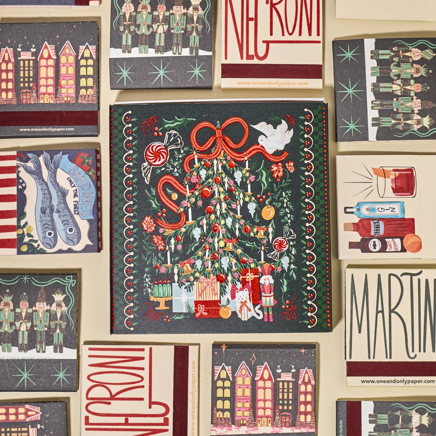 Collection of decorative matches with various designs and text on a beige background