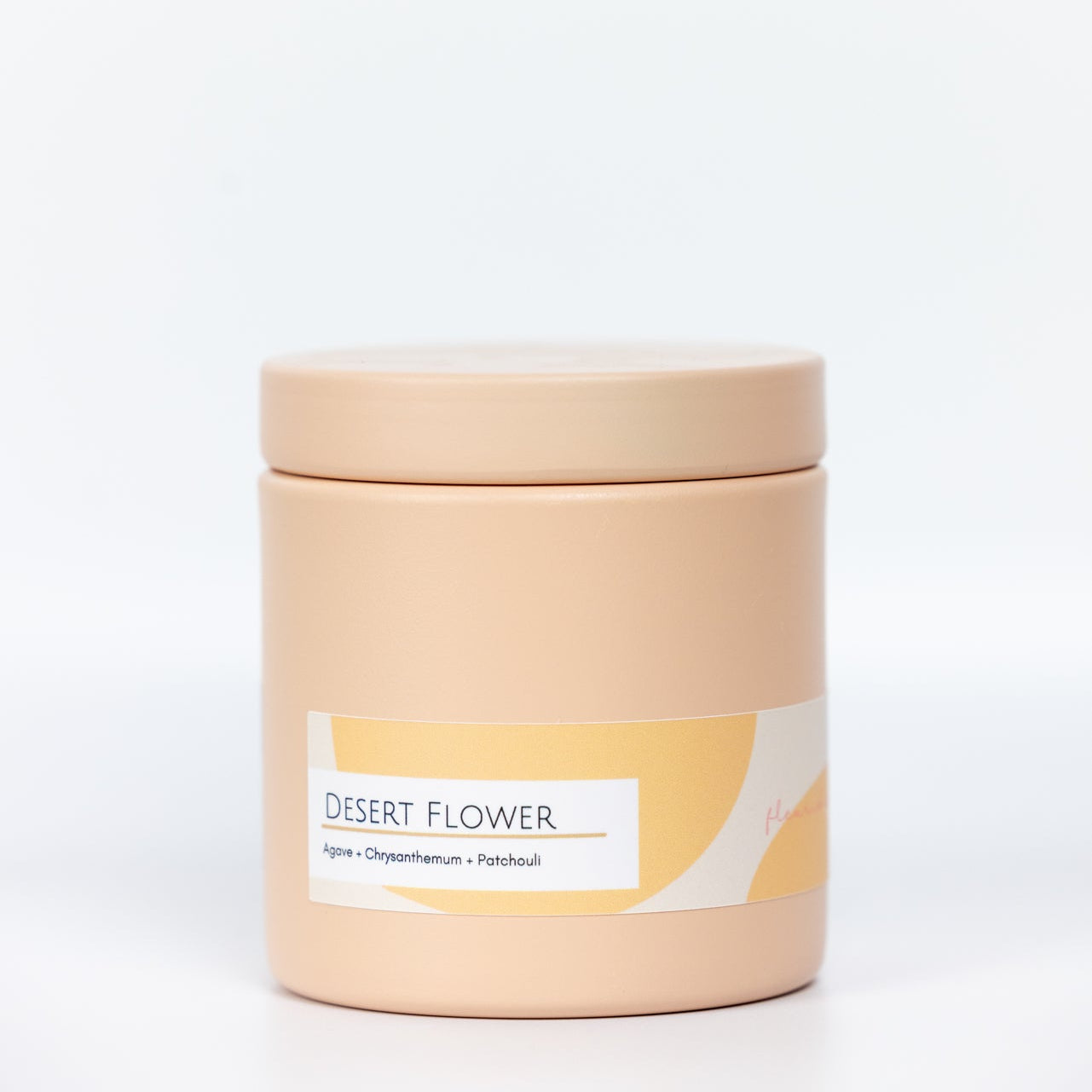 Beige candle jar with a label on a white background