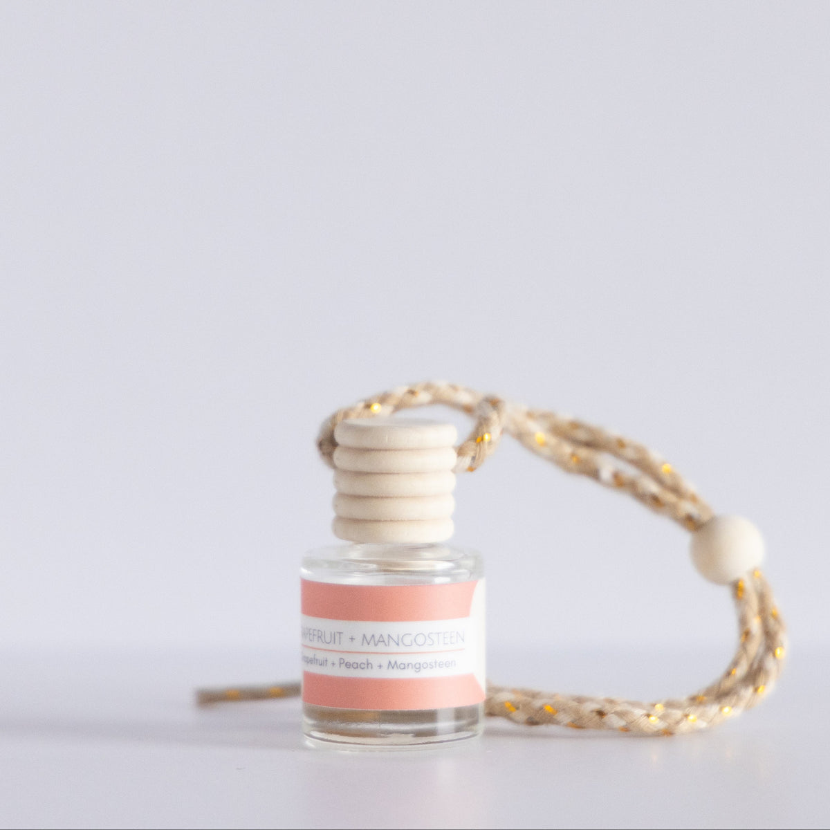 Small bottle with a pink label on a white background