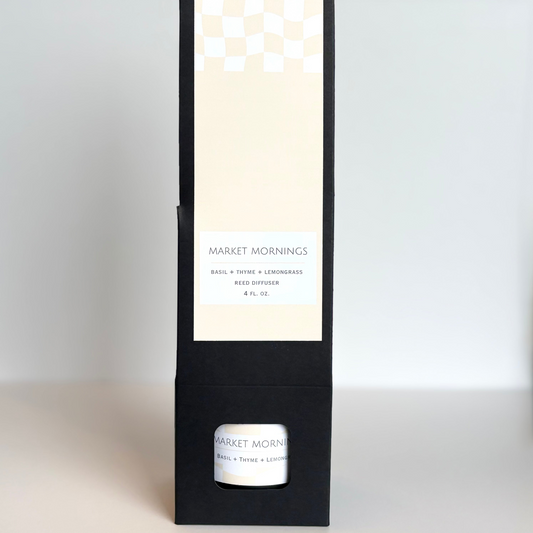Candle packaging with a white candle inside on a light gray background