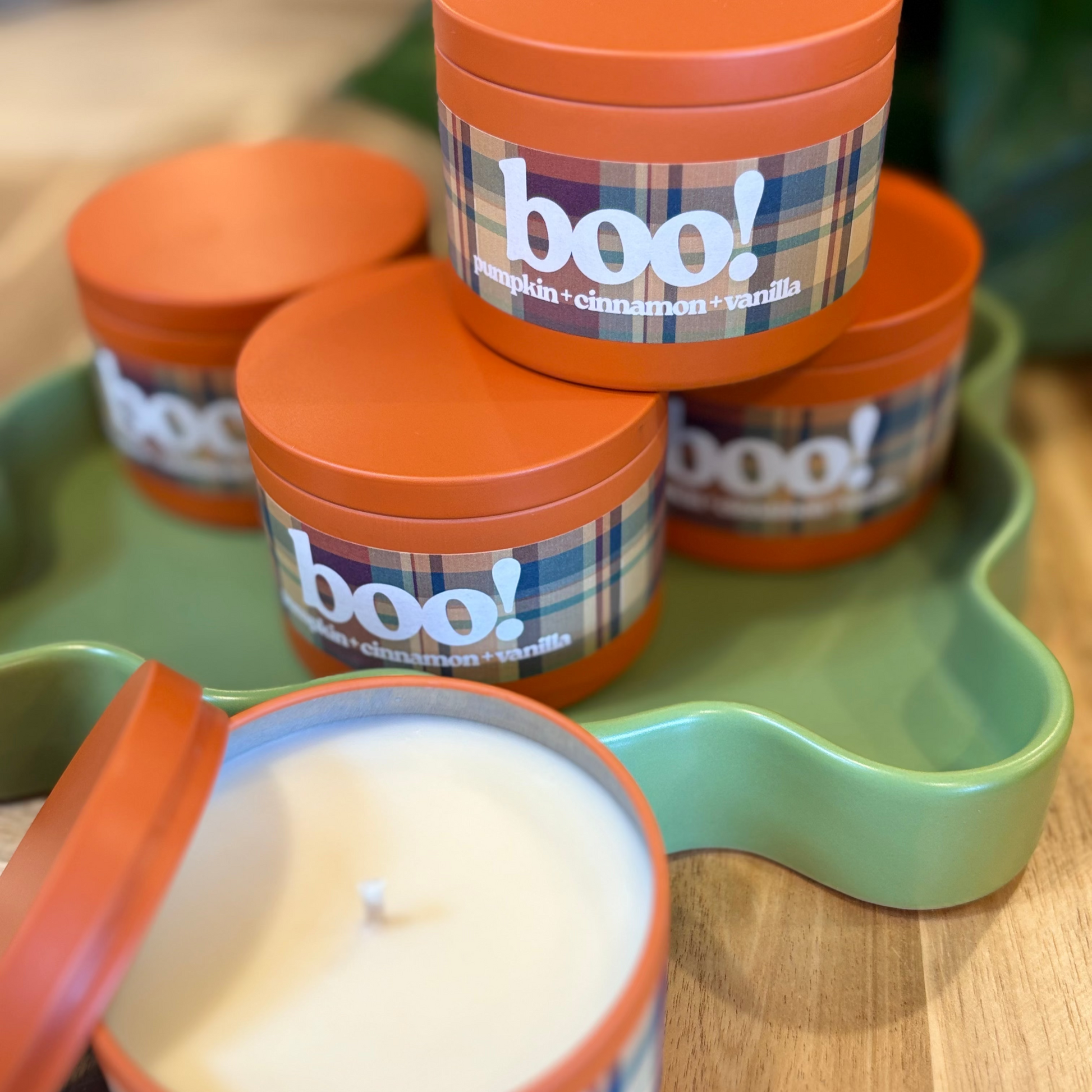 Candle jars with 'boo!' label on a green tray