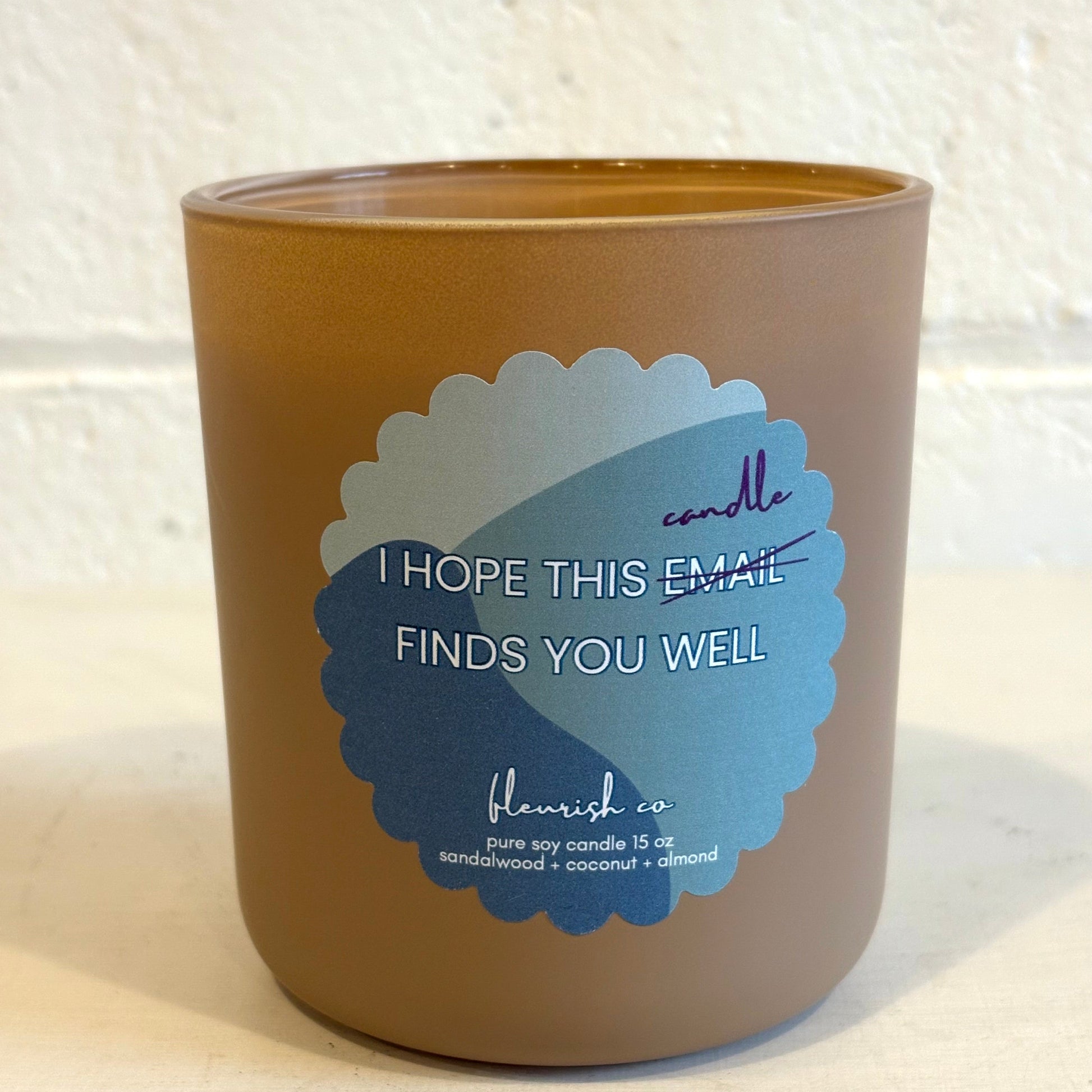 Candle with a blue label on a textured white background
