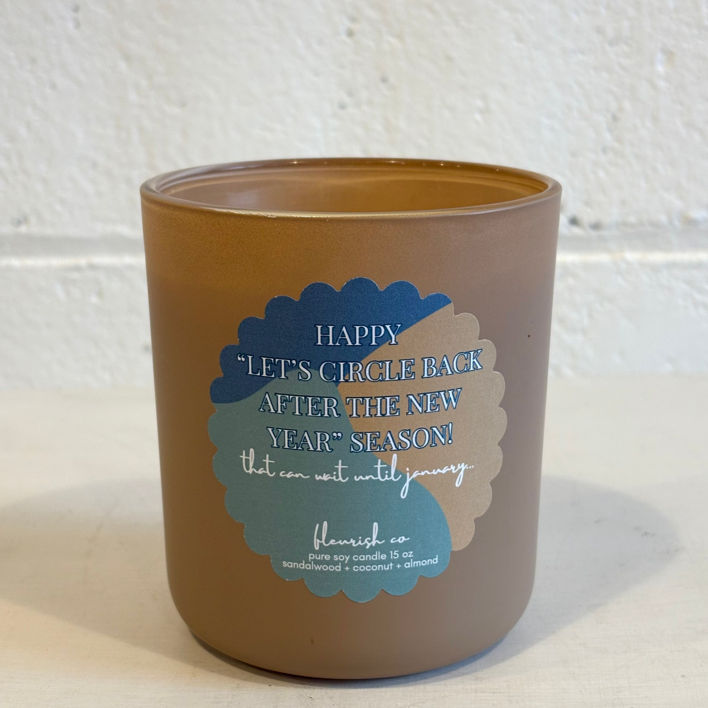 Brown ceramic jar with blue text on a white background