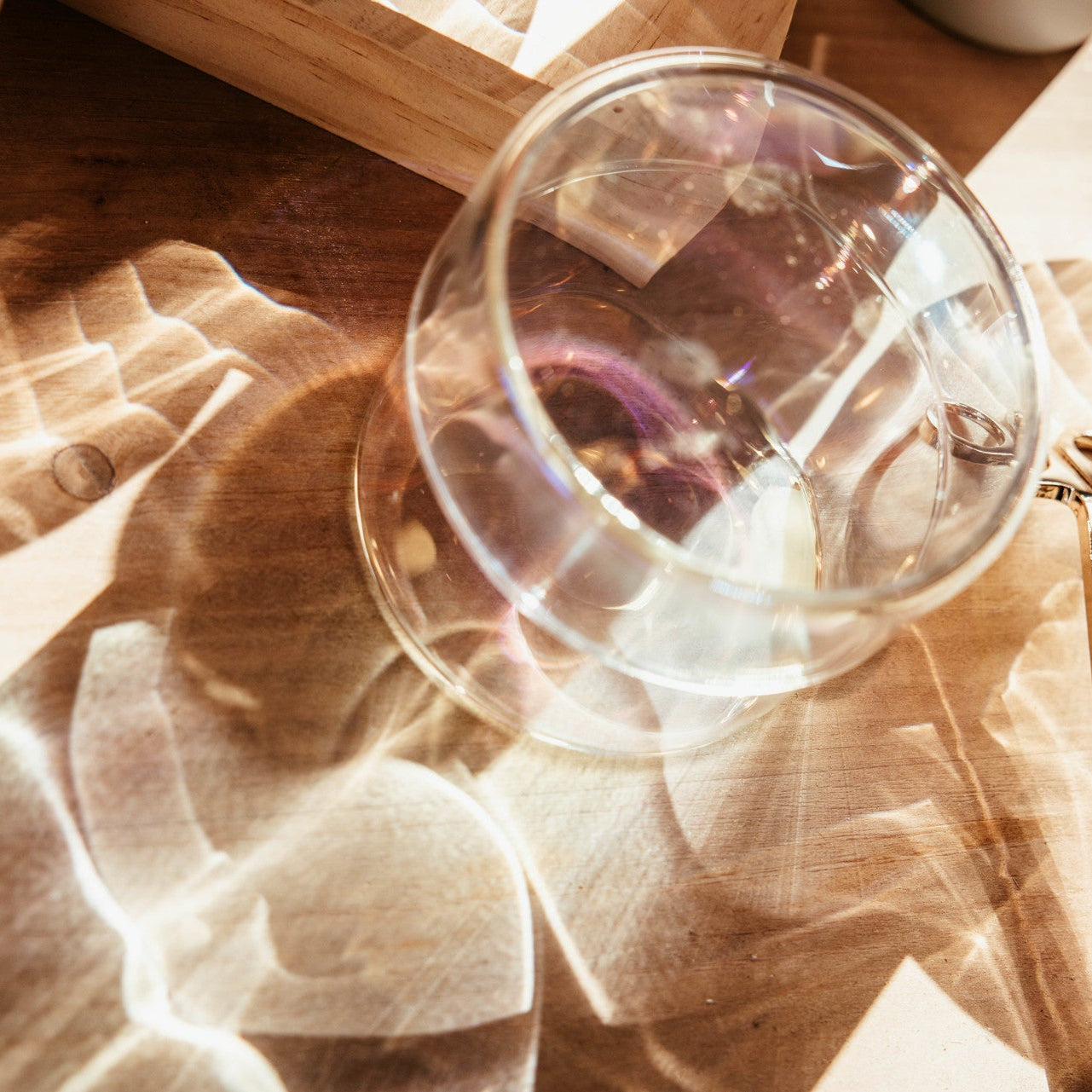 Clear glass on a wooden surface with a blurred background