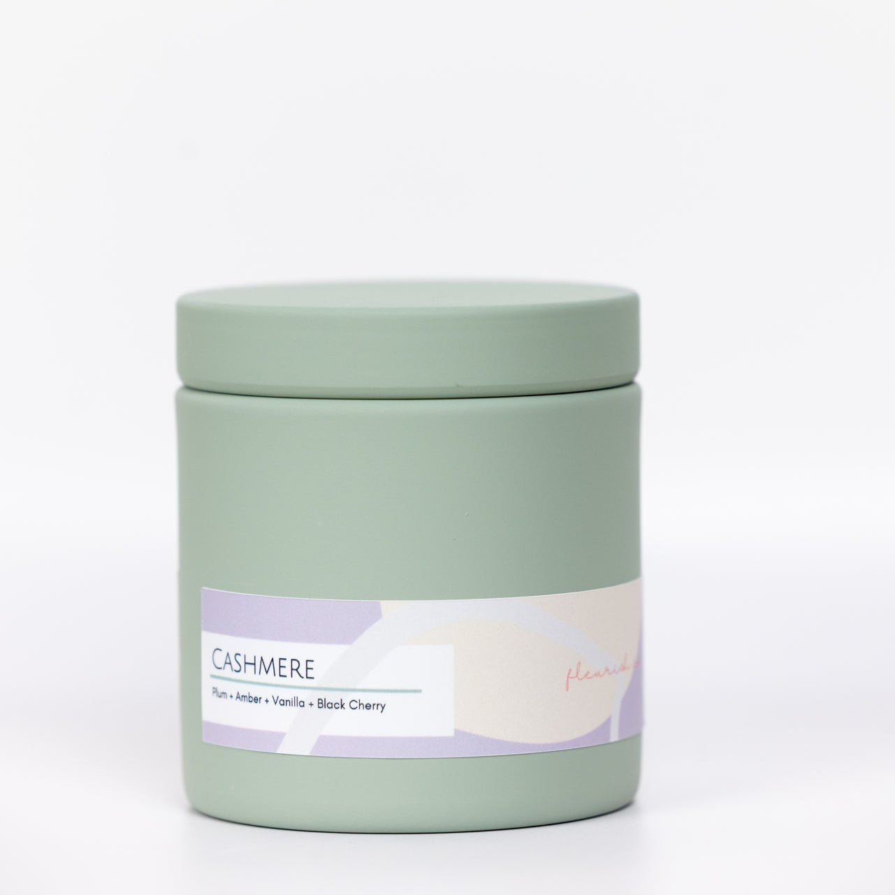 Green candle jar with a label on a white background