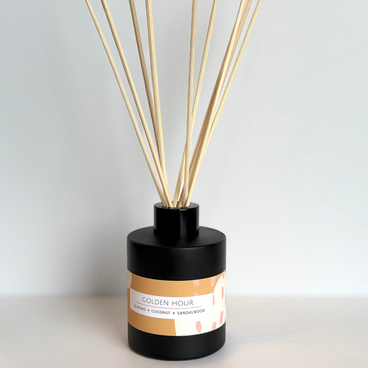 Black diffuser with wooden sticks labeled 'Golden Hour' on a white background
