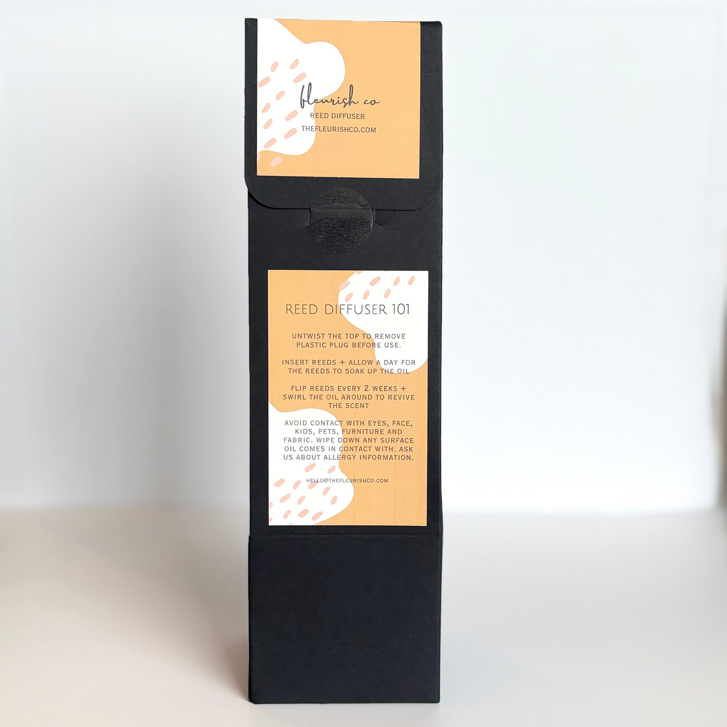 Flower diffuser packaging with orange and white design on a white background