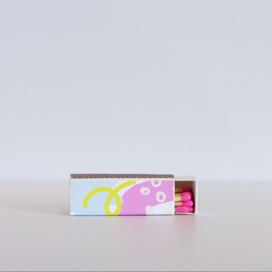 Matchbox with colorful design on a white background