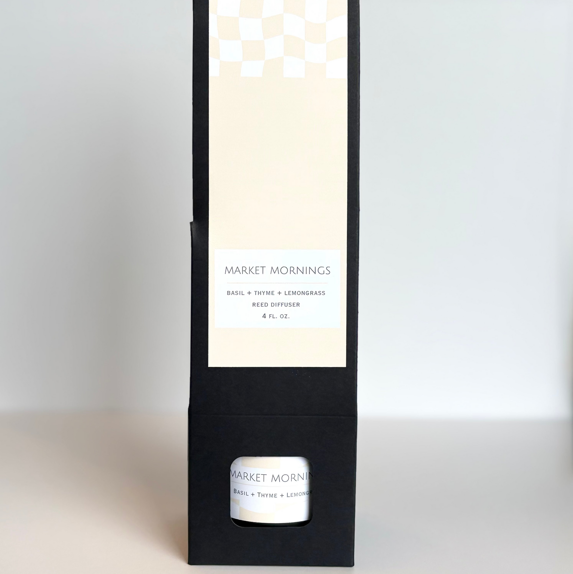 Candle packaging with a white candle inside on a light gray background
