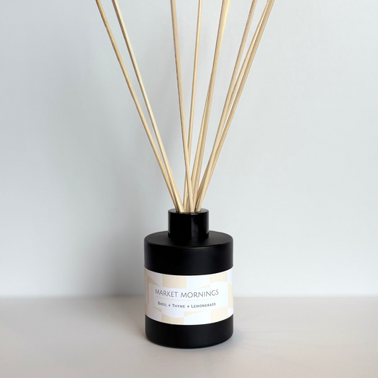 Diffuser with wooden sticks on a light gray background
