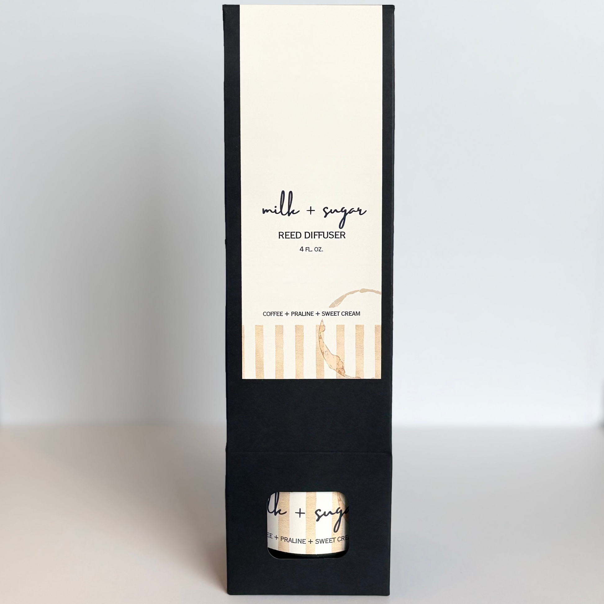 Reed diffuser packaging with a black and white design on a white background