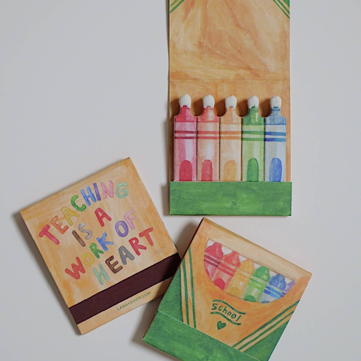 Set of colorful stationery items including a small book and a box with crayon design on a white background.