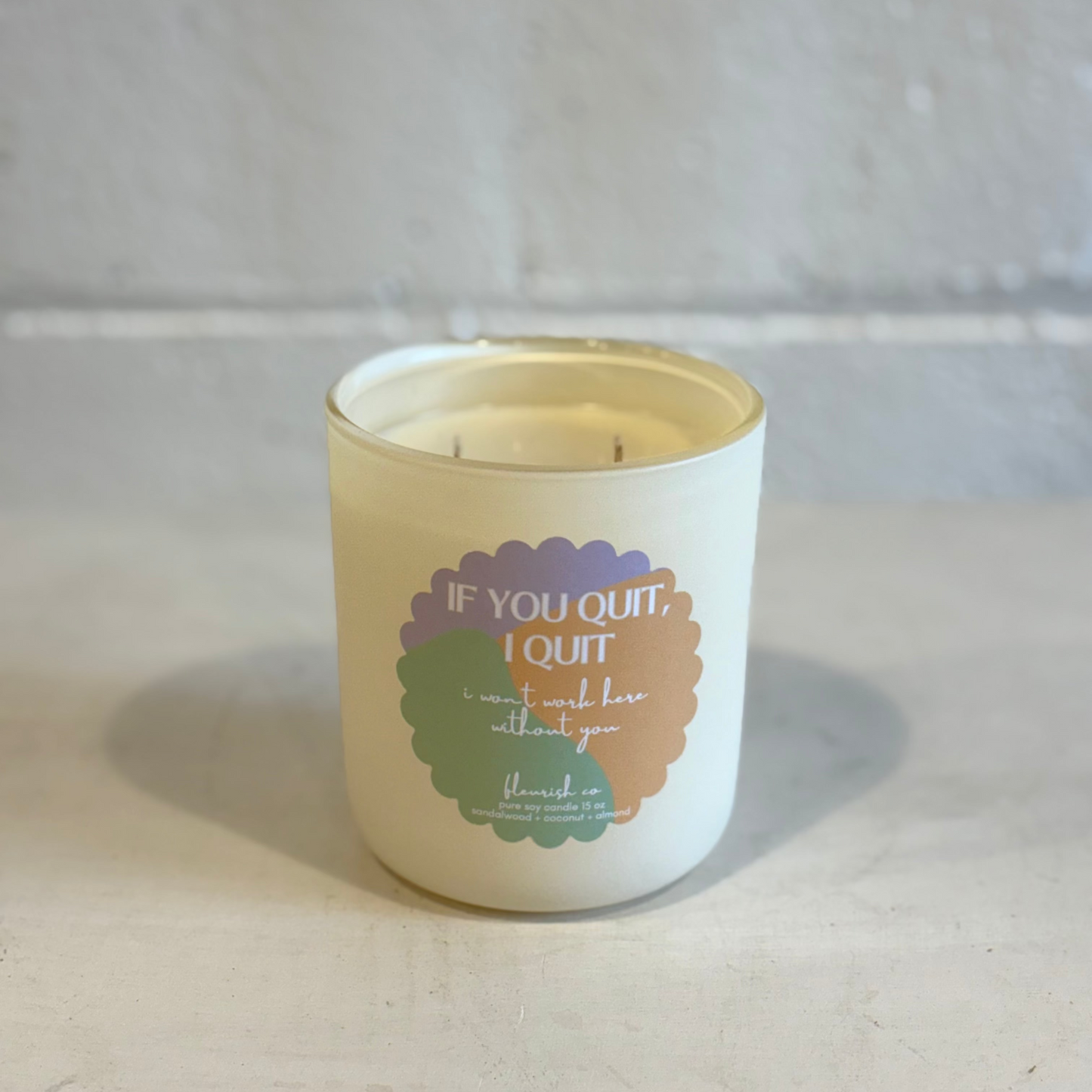 Candle with a motivational quote on a neutral background