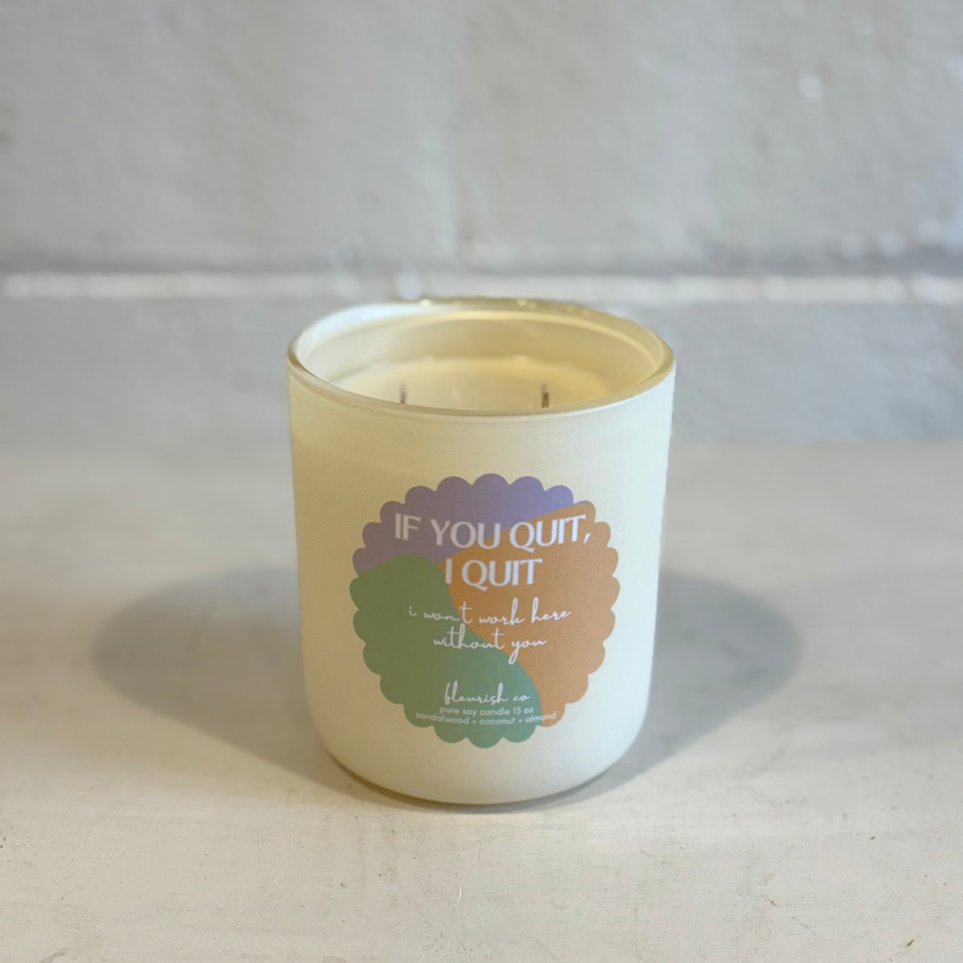 Candle with a motivational quote on a neutral background