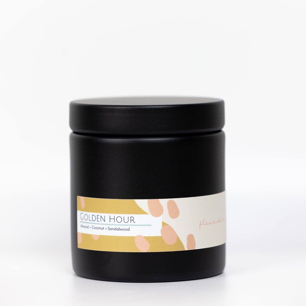 Black candle jar with a label on a white background